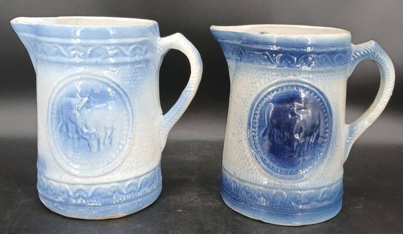 (2) Blue and White Stoneware Pitchers with Relief Designs