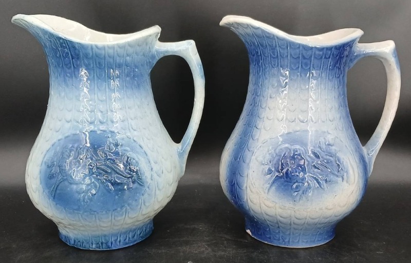 (2) Blue and White Stoneware Pitchers with Relief Designs