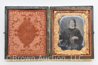 Daguerreotype photo in embossed case, image of woman with rose tinted cheeks