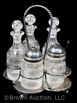 5 pc. castor set (bottles all match), holder sits atop a silverplate scalloped and ftd. plateau