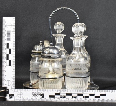 5 pc. castor set (bottles all match), holder sits atop a silverplate scalloped and ftd. plateau - 31