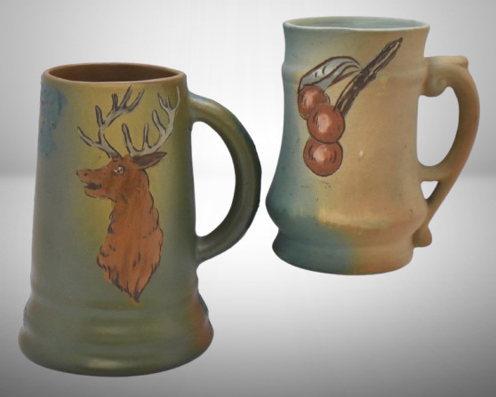 (2) Mrkd. Weller mugs: 5.75" Dickensware, stag; 5" Floretta, cherries