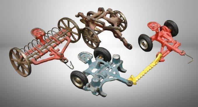 (4) Arcade cast iron toy implements: hay rake, 2-botttom plow, sickle-bar mower & 2-row planter