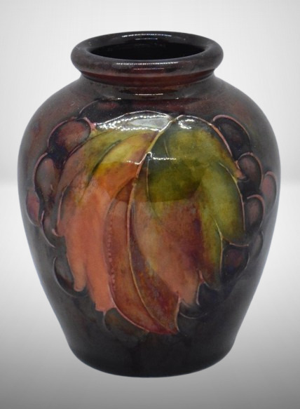 Mrkd. Moorcroft leaf and berry 3.25" vase, paper label