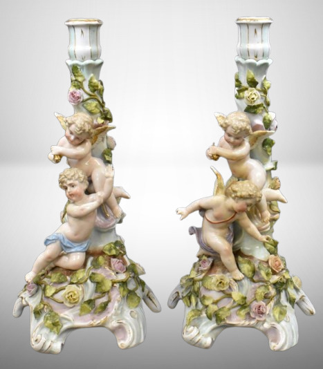 Pair of Meissen ornate candlesticks w/ figural cherubs and flowers, 13.5" tall