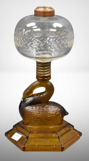 Atterbury amber figural swan stem kerosene lamp, 9"h