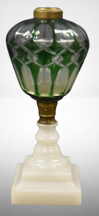 Emerald green cut-to-clear kerosene lamp on white marble stand