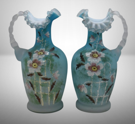 (2) Cased satin glass 10" ewers, floral designs on blue