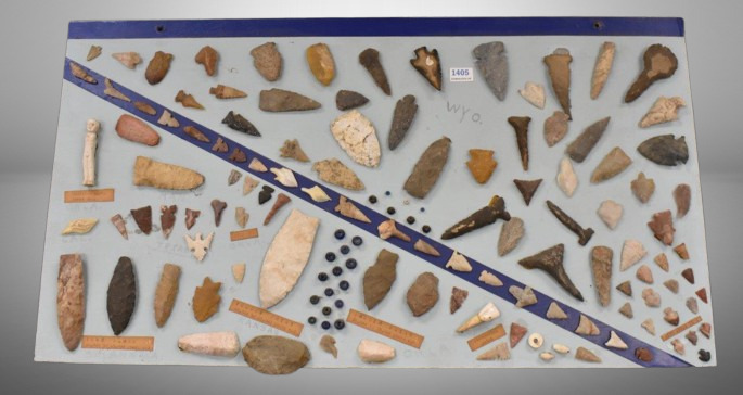 Display board of Native American items incl. arrowheads, drills, bird arrow tips, medicine man's charm doll, eta.