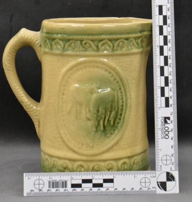 Yellow ware 8" pitcher w/ design of grazing cows - 7