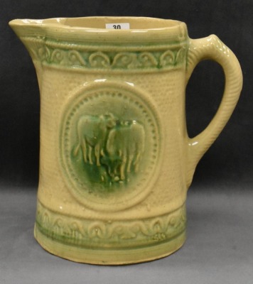 Yellow ware 8" pitcher w/ design of grazing cows - 8