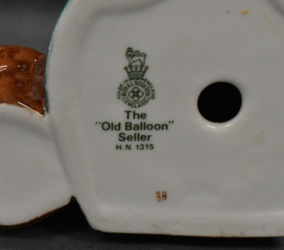 (2) Royal Doulton figurines: HN 1315 The Old Balloon Seller, 7.5"; HN 1843 Biddy Pennyfarthing, 8.5" - 9
