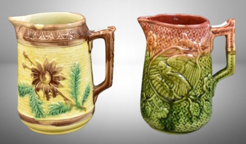 (2) English Majolica 7" pitchers: sunflower on basketweave; bird surrounded by foliage