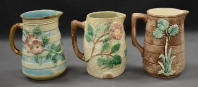 (3) Majolica 6" milk pitchers, all w/ plant or floral decorations - 3