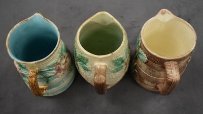 (3) Majolica 6" milk pitchers, all w/ plant or floral decorations - 5