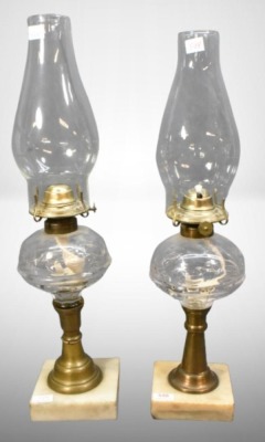 (2) Clear Glass oil lamps on brass columns and marble bases, inverted thumbprint style design