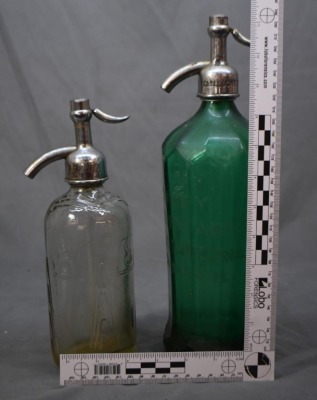 (2) Seltzer bottles: 1-"Schultz Carbonic", clear, 9.5"h; 1-mrkd. Czechoslovakis, green, 12.5"h - 11