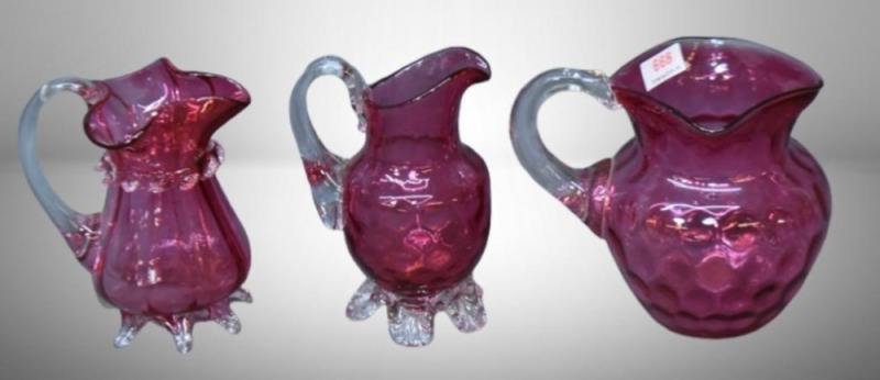 (3) Cranberry pitchers: 2-5" w/ clear applied feet and handles; 1-4.5" Inverted Thumbprint, tri-spout