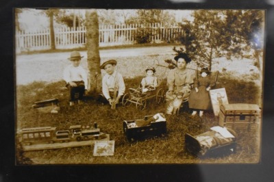 Framed photo of kids sitting outside with their toys, circa 1900 - 3