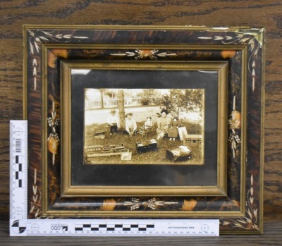 Framed photo of kids sitting outside with their toys, circa 1900 - 6