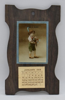 Earl E. Baird Christmas Remembrance advertising calendar on wooden backer, Jan - Dec. 1918