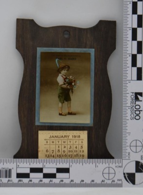 Earl E. Baird Christmas Remembrance advertising calendar on wooden backer, Jan - Dec. 1918 - 6